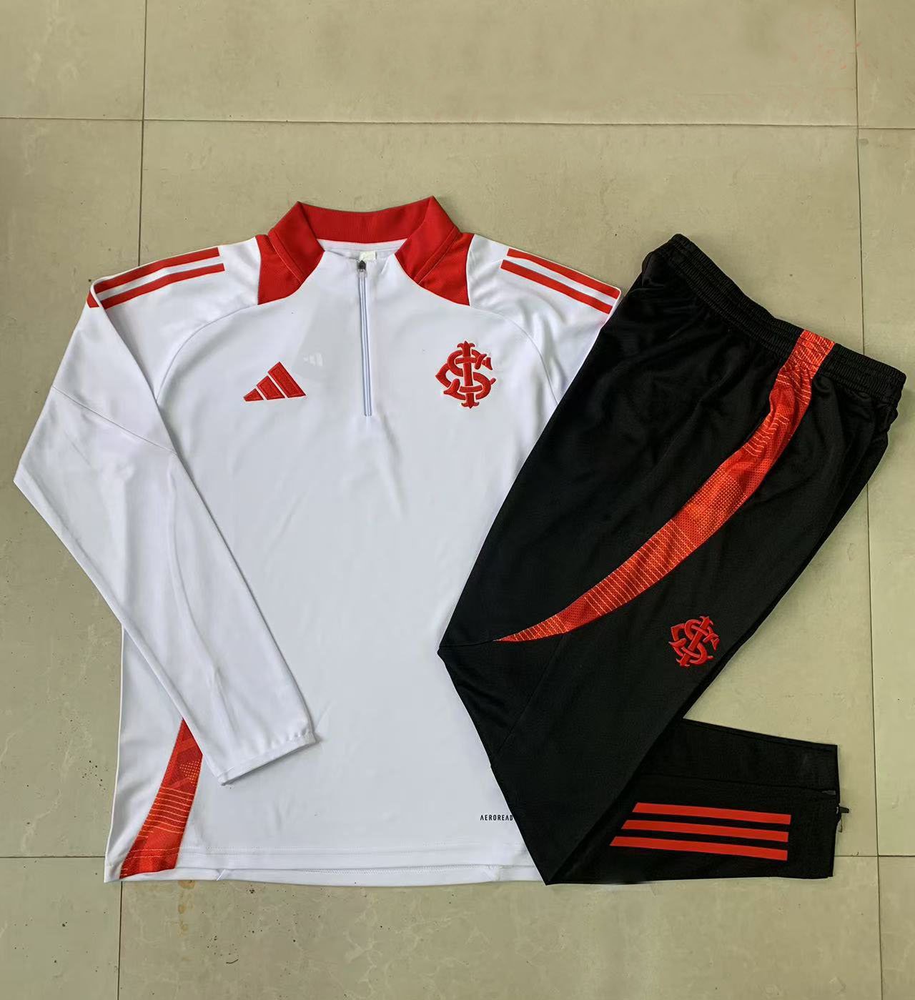 Sueter y pantalon unisex Internacional 2024/25 con media cremallera 8151